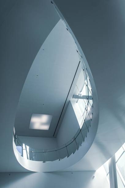 istock Low angle of a white spiral staircase in a modern building 1488083758
