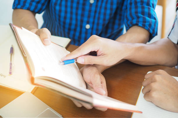 istock High school or college students are studying and reading together.  Share the knowledge and explain before the exam. 1488084936