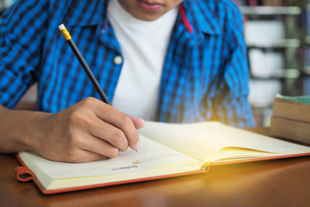 istock High school students are writing books in the library. 1488084951