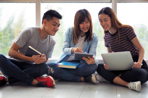 istock Student groups are viewing information in the tablet. Having a gesture of agreement and smiling, happy to study together. 1488085067