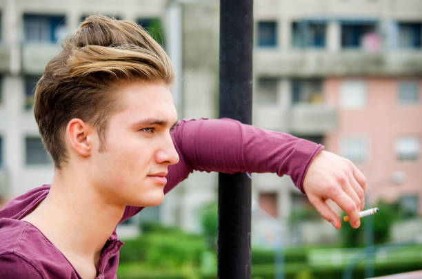 istock Attractive blue eyed, blond young man smoking 1488085389