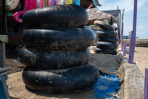 the inner tire of a truck used as a swimming float on the beach