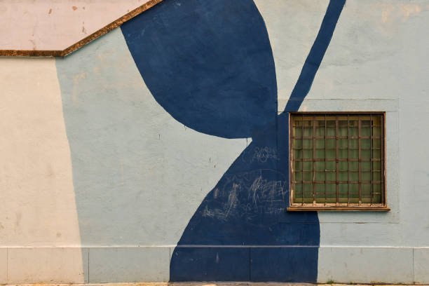 istock Detail of a blue painted wall with a rusty iron window 1488087376