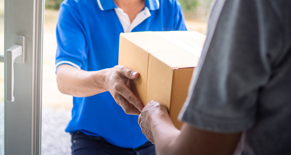 woman hand pick up the delivery box from deliveryman