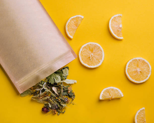 Paper bag with dry loose leaf tea with lemon slices stock photo