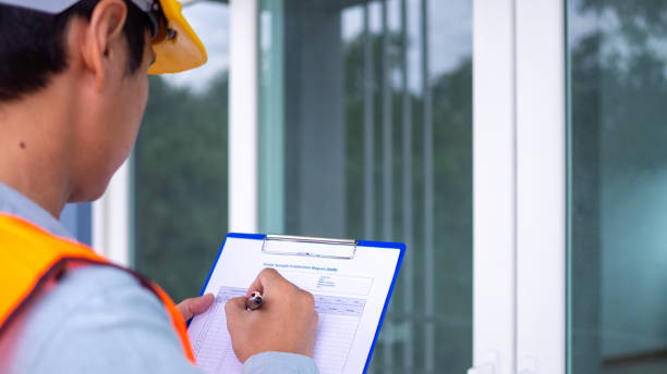 istock The inspector or engineer is checking the building structure and the requirements of the wall paint. After the renovation is completed 1488090436