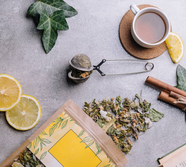 istock cup of tea with lemon slices and tea packaging 1488090657