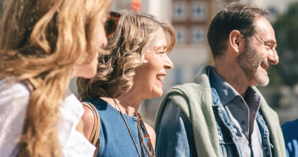 istock Smiling mature friends walking on street 1488090942