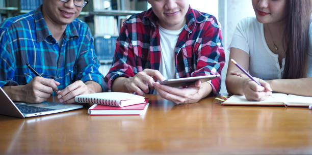 istock Student groups are viewing information in books and laptops. Willing to study together 1488097445