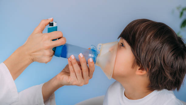 istock Pulmonologist Helping Little Boy with Aero chamber. 1488097519