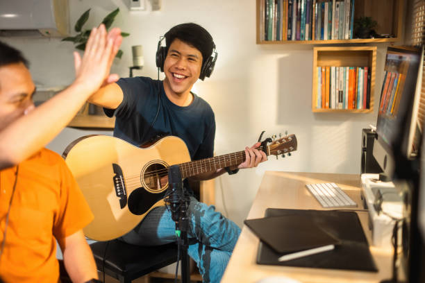 istock Group of Asian men making music at home studio. they have succeeded 1488098554