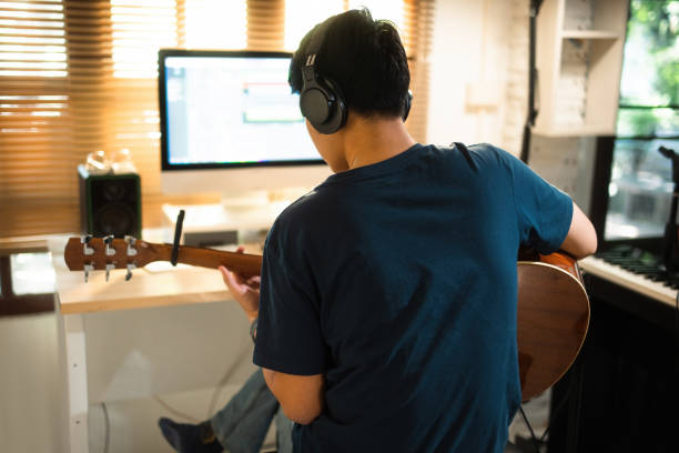 istock Asian man making music at home studio 1488098572