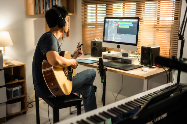 istock Asian man making music at home studio 1488098588