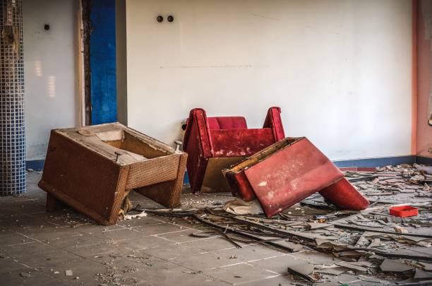 Old chairs and rubble in abandoned house.