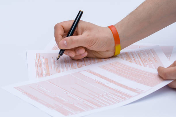 istock hand pen and forms. filling in applications 1488098969