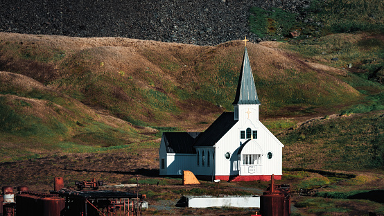 Church of Grytviken - Norwegian Anglican Whalers Church spot lit from the setting sun.The Neo-Gothic church was pre-built in the year 1912 in Norway and shipped and erected in Grytviken by the Norwegian Whalers. Grytviken, South Georgia Island, Sub Antarctic Islands, British Overseas Territories, UK