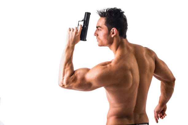 athletic topless mann mit pistole auf weiß - sensuality men shirtless studio shot stock-fotos und bilder