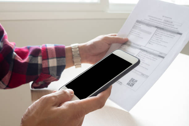 istock hand uses smartphone scan QR code or barcode to pay monthly phone bills. Use phone connect to the internet and accessing online payment applications. payment transferre money through the website. 1488102311