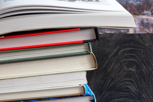 istock Open book on a pile of books 1488102625