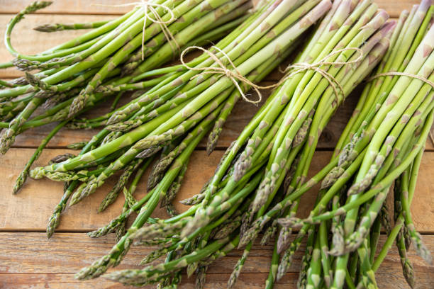istock Bunch of raw asparagus spears, close up 1488104248