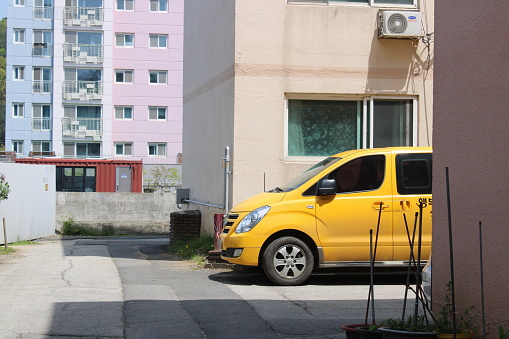 Gapyeong, Korea-April 27, 2023: Taxi van waiting beside traditional Korean villa building