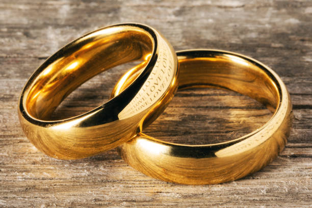 istock Golden wedding rings on wood 1488109025