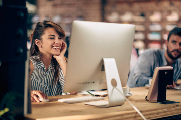 istock Beautiful young woman feeling joyful at work, working on computer. 1488110395