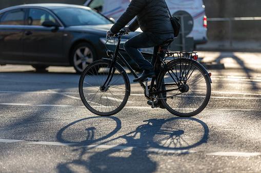 cyclist with black bike in backlight