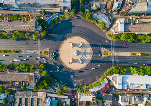 Aerial view of Democracy monument, a roundabout, with cars on busy street road in Bangkok Downtown skyline, urban city at sunset, Thailand. Landmark architecture landscape.