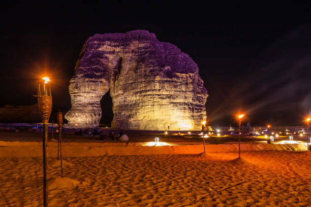 istock Illuminated by burning torches sandstone elephant rock erosion monolith standing in the night desert, Al Ula, Saudi Arabia 1488113517
