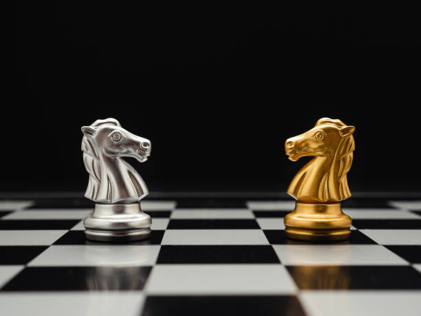 istock Chess pieces on board game planning and competition on black background. 1488115357