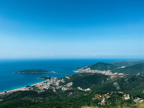 istock Mountain range near the blue sea merging with the clear sky 1488115359
