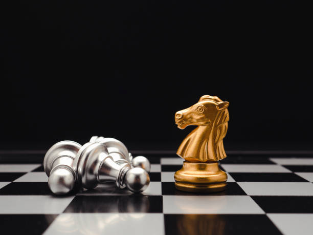 istock Chess pieces on board game planning and competition on black background. 1488115719