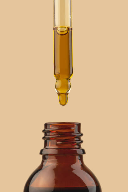 istock Pipettes with oil on beige isolated background 1488121670
