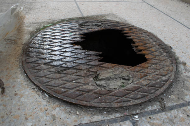 istock Sewer or gutter broken from the middle moldy cover. 1488121795