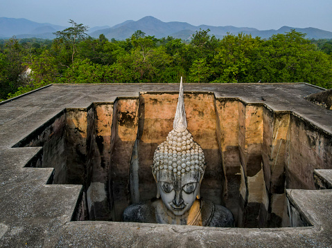 Drone point of view of Buddha in Wat Si Chum, Sukhothai, Thailand