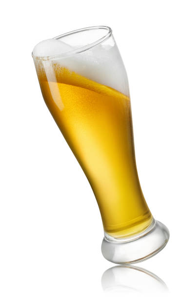 glass of light beer with foam isolated on white falling glass of light beer with foam isolated on white background beer glass splash stock pictures, royalty-free photos & images