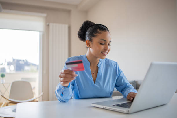 istock Cheerful  woman doing online shopping 1488123955