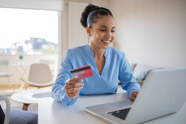 istock Cheerful  woman doing online shopping 1488123960