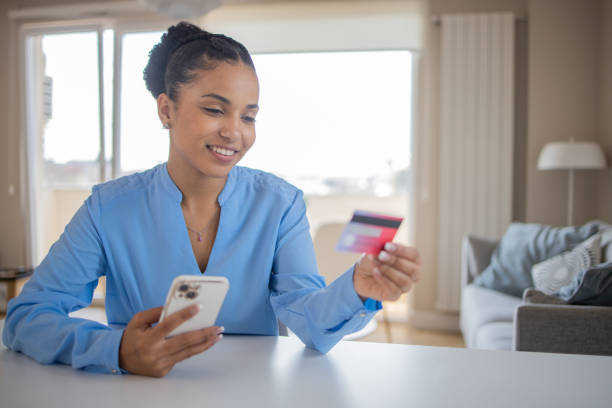 istock Cheerful  woman doing online shopping 1488123966