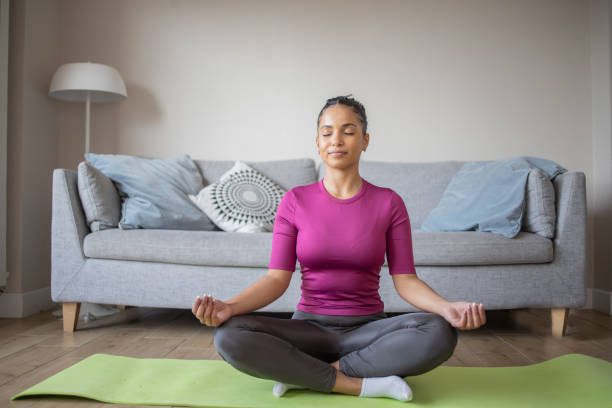 istock Young woman at home keeping fit by exercising 1488124593