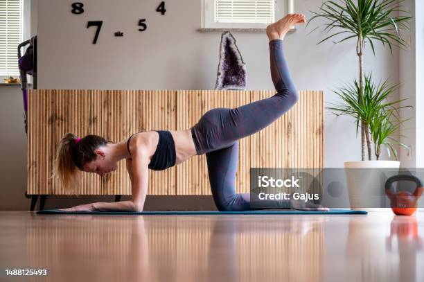 Fit Young Woman In Sportswear Working Out At Home In Living Room Stock Photo - Download Image Now
