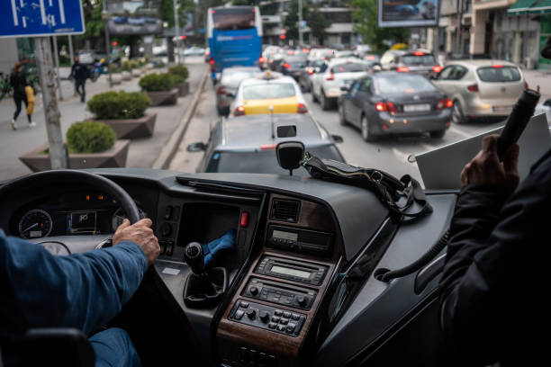 Bus driver holding steering wheel rap is talking close up on hands horizontal bus cockpit photo