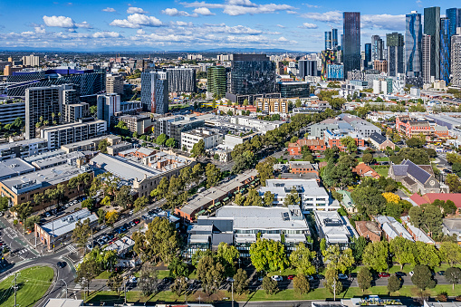 Not the usual cityscape view of Melbourne: aerial view of northeast corner of Melbourne's CBD taken from North Melbourne showing the contrast of old and new architecture in the foreground. Included in the view are the Parkville hospital complex, and buildings associated with both Melbourne and RMIT Universities. Tree-lined streets low-rise buildings and parklands in established older suburb, with modern high-rise architecture on perimeter of the city.