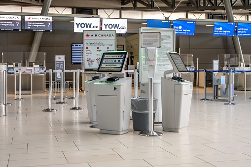 Ottawa, Canada – October 21, 2022: Ottawa, Ontario - October 21, 2022:  Empty self check-in kiosks and departures facilities in the Ottawa International Airport.