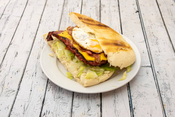 istock Giant burger with fried egg, cheddar cheese, fried bacon and iceberg lettuce 1488133555