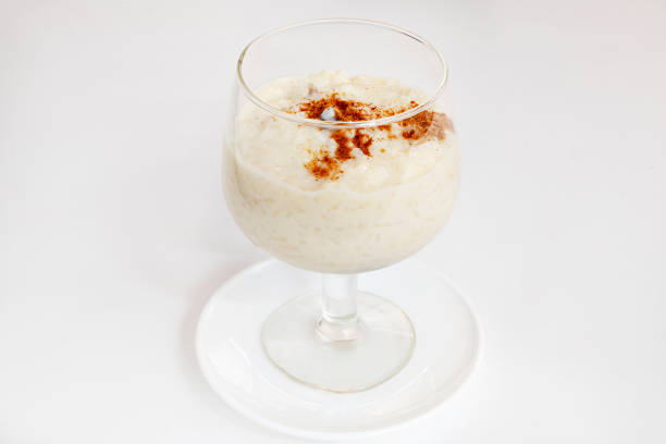 Bowl of sweet rice pudding covered three quarters with ground cinnamon