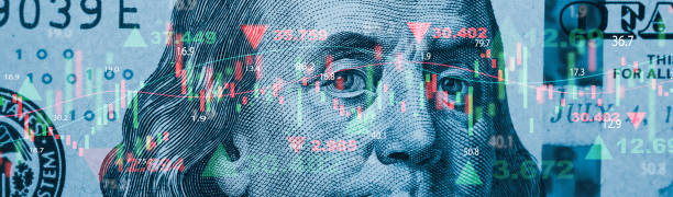 istock Closeup Benjamin Franklin face on USD banknote with stock market chart graph for currency exchange and global trade forex concept. 1488134697