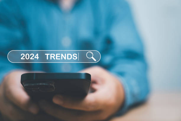 istock Businessman using smartphone to input keyword of 2024 trends inside infographic searching  tool bar for marketing monitor and business planing change concept. 1488134803