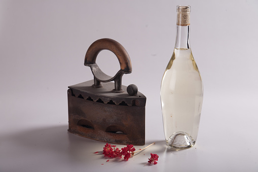 iron flowers and bottle of alcohol